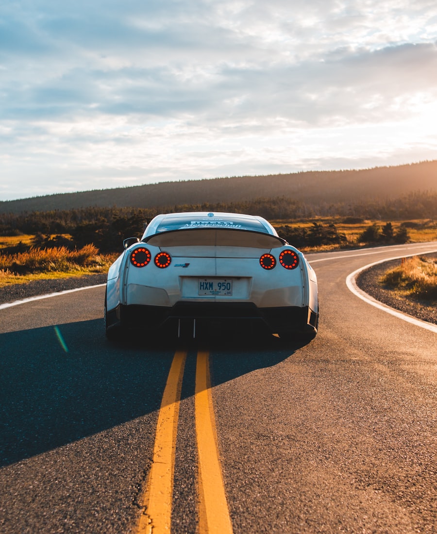 A car heading down an open road into the evening sun